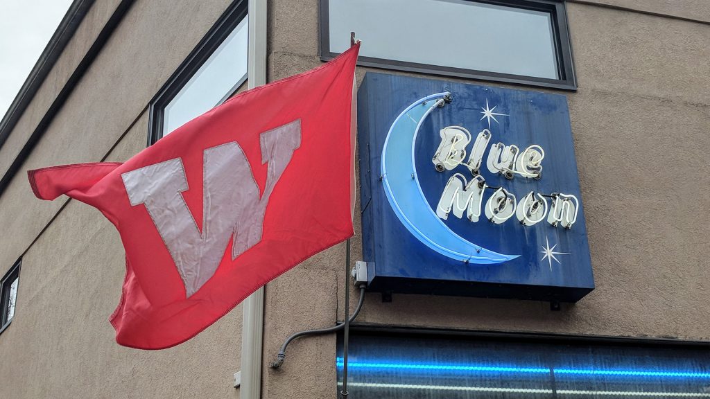 Blue Moon Bar & Grill sign with UW Wisconsin flag